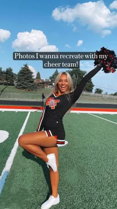 a cheerleader is posing on the field with her pom poms