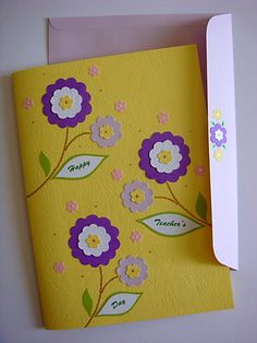 a yellow card with purple and white flowers on it