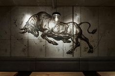 a painting of a bull is on the wall