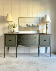 two lamps are sitting on top of an old desk in the corner of a room