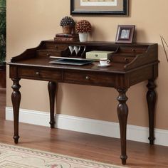 a wooden desk sitting in front of a wall with pictures on it's side