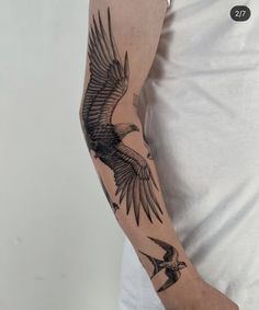 a man with a bird tattoo on his arm