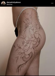 a woman's thigh with flowers and a fish on it