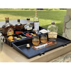 an outdoor bar with liquor bottles and glasses on it