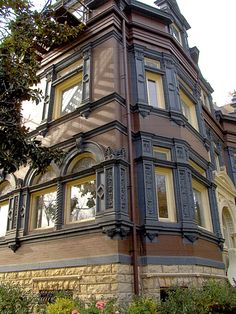 an old building with many windows and a clock on the top of it's tower