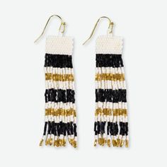 For the fashion lover with an eclectic aesthetic and a knack for throwing curveballs, we present the Billie Beaded Fringe Earrings. These stunning earrings blend graphic lines with layers of shimmery fringe for a vibe that's equal parts modern and gloriously unrestrained. With their bold, contrasting stripes of black and gold seed beads, the Billie earrings instantly draw the eye. But look closer and you'll find they're far from a basic striped accessory. Tiers of swingy beaded fringe bring unex Scout Bags, Eclectic Aesthetic, Shimmer Shine, Human Hand, Shimmer N Shine, Horizontal Stripes, Book Candle, Beaded Fringe, Stunning Earrings