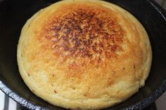 a close up of a bread in a skillet on a stove top burner