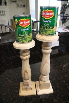 two canisters sitting on top of each other on a counter in a kitchen