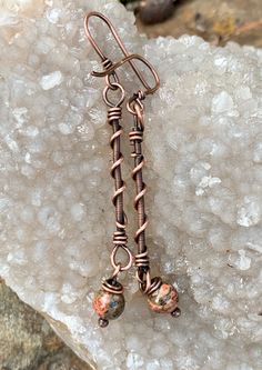 Hand coiled copper and copper swirls with Leopard Skin Jasper dangles on these lightweight earrings with handmade copper ear wires.Approximately 2 1/2" from the top of the ear wire and 1/4" wide.These earrings have been antiqued, polished and sealed.Sealed with Protectaclear ProtectaClear is a clear, protective coating that is tough enough to protect jewelry and is safe for wear against skin. ProtectaClear is practically invisible once applied and will seal and protect jewelry from tarnish, oxid Leopard Skin Jasper, Wire Pendants, Ear Art, Leopard Skin, Diy Wire Jewelry, Wire Pendant, Ear Rings, Lightweight Earrings, Handmade Copper