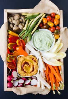 a tray filled with veggies and dips