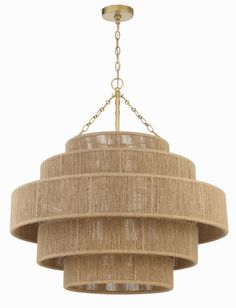 a chandelier hanging from the ceiling with beige fabric coverings and gold chains