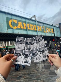 someone holding up some old black and white photos in front of the camden stock building