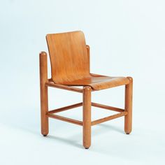 a wooden chair sitting on top of a white floor