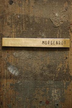 a metal name plate on the side of a wooden door that says morgenrot