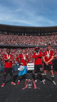 the soccer team is posing with their trophies