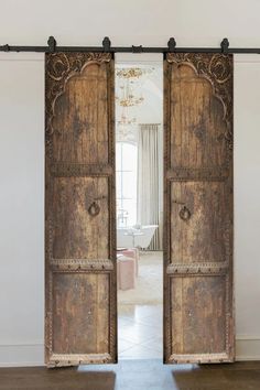 an open wooden door in the middle of a room