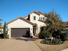 a large house with two garages in front of it