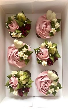 six cupcakes in a box decorated with flowers