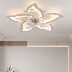 a living room filled with furniture and a white ceiling fan mounted on the wall above it