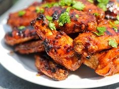 an image of chicken wings on a plate with sauce and herbs in the middle, as well as instructions for how to cook them