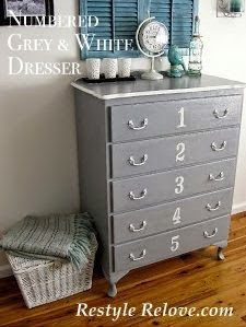 the dresser is painted gray and white with lots of drawers on each drawer, along with a clock