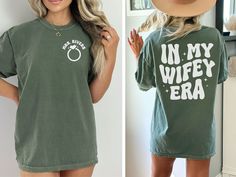 a woman wearing a green shirt that says un my wife era