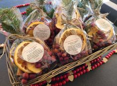 baskets filled with oranges, cranberries and pine cones on top of a table