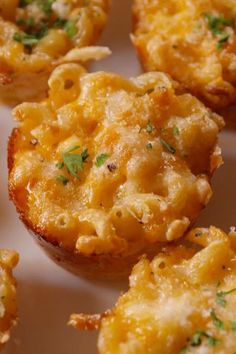 mini macaroni and cheese muffins on a white plate with parsley