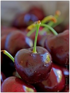 a bunch of cherries sitting on top of each other