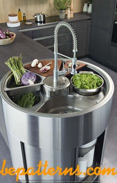 a stainless steel sink in a kitchen with vegetables on the counter