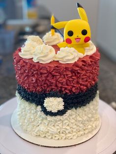 a pokemon cake with white frosting and sprinkles