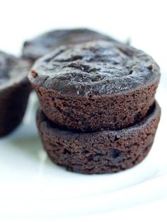 three chocolate muffins stacked on top of each other