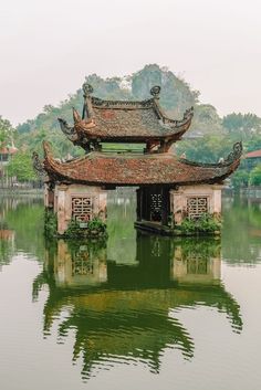 an old building sitting on top of a lake