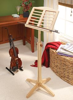 a violin is sitting on the floor next to a desk with a musical instrument in it