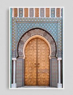 an intricately decorated door in the middle of a building with blue and gold tiles on it