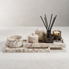 a marble tray with candles and other items