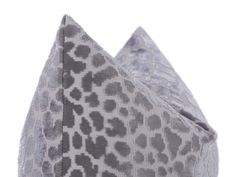 a gray and white pillow with an animal print pattern