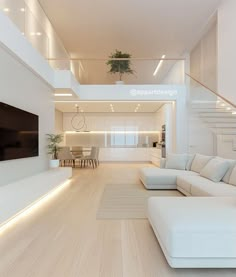 a living room with white furniture and stairs