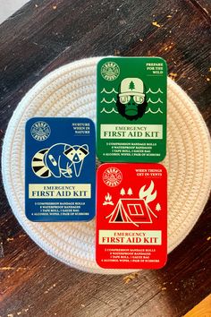 the first aid kit is sitting on top of a white frisbee that's attached to a wooden table