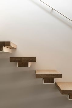 a set of wooden stairs in a white room