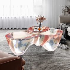 a glass coffee table in the middle of a living room