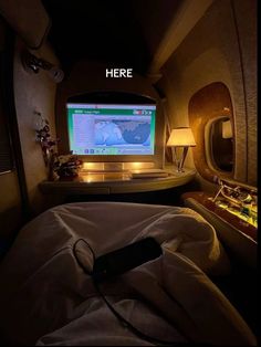 there is a computer screen in the middle of an airplane's cabin bed area