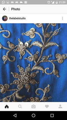 an image of a blue dress with gold embroidery on the bottom and side, which is being taken from instagram