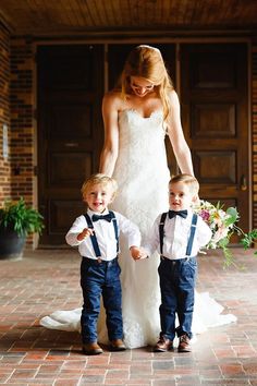 a woman and two young boys standing next to each other