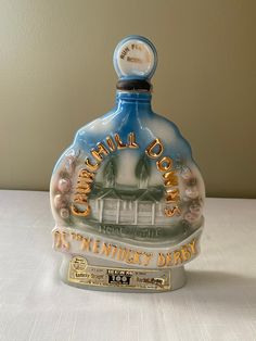 a blue and white bottle sitting on top of a table