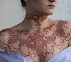 a woman with henna on her chest