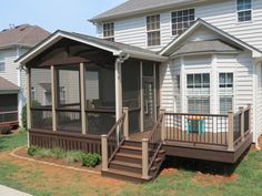 a house with a screened porch in the front yard