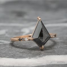 a black diamond ring sitting on top of a wooden table