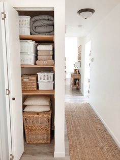 the closet is full of linens, baskets and other things to put in it