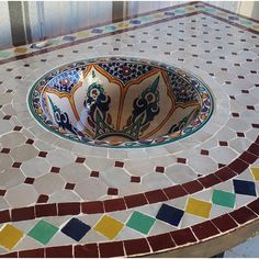 a bowl sitting on top of a tiled counter